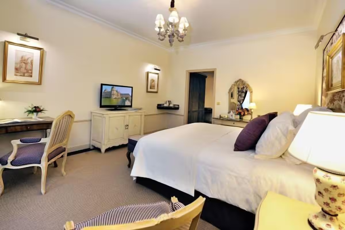 Luxury hotel room with chandelier and elegant furniture